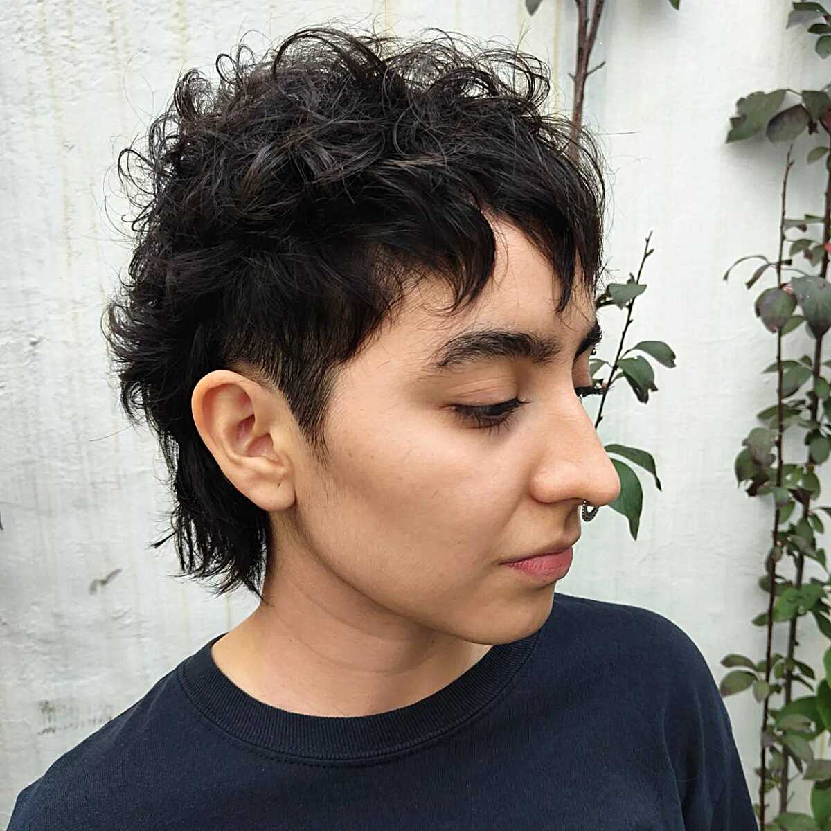 Short curly dark pixie shag with tapered nape