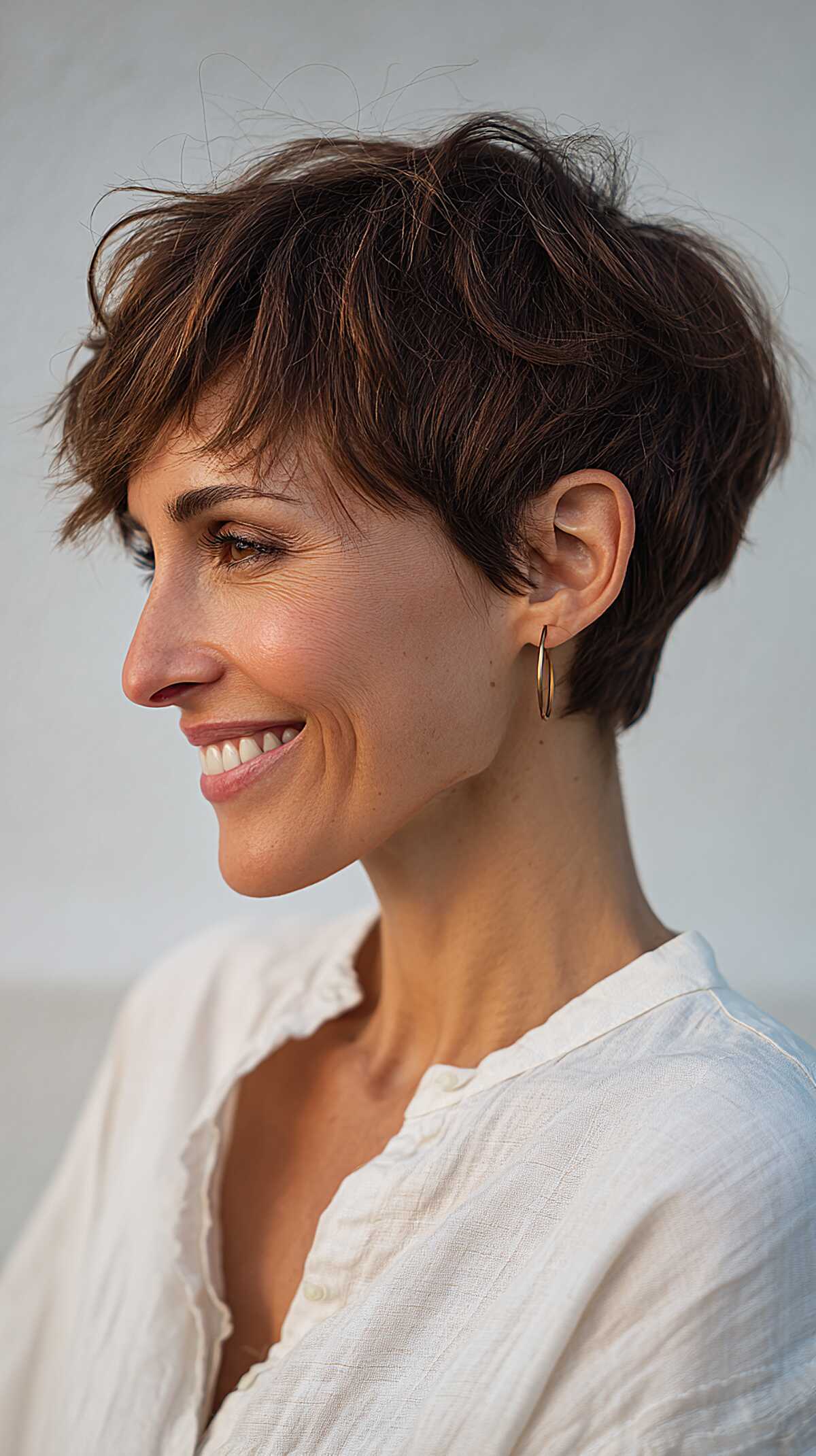 Tousled brunette angled pixie with lived-in texture