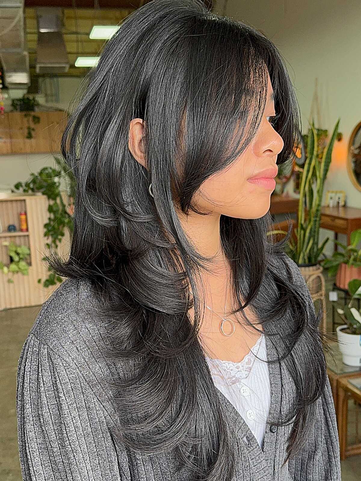 Long voluminous black hush cut with curtain fringe layers