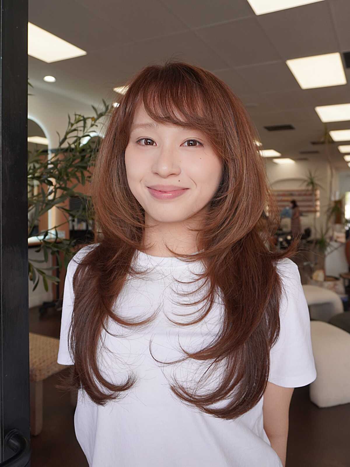 Long warm auburn hush cut with soft feathered fringe