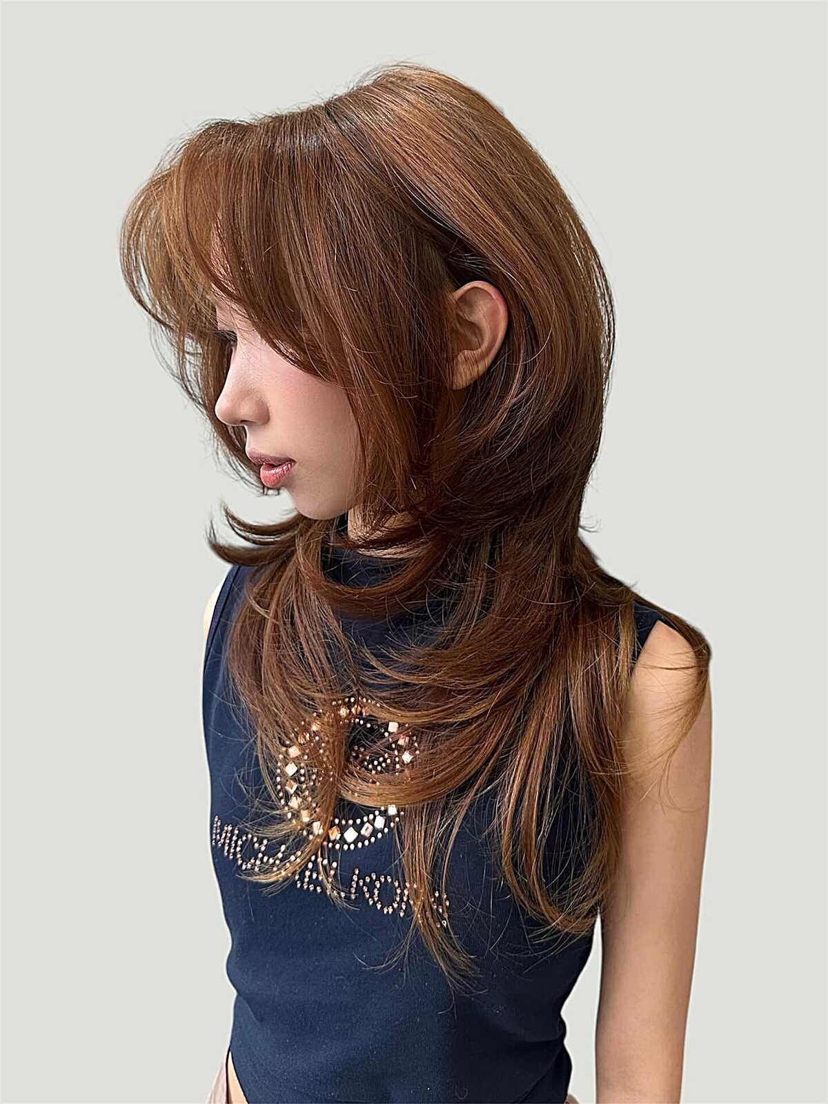 Long warm copper hush cut with sweeping feathered layers