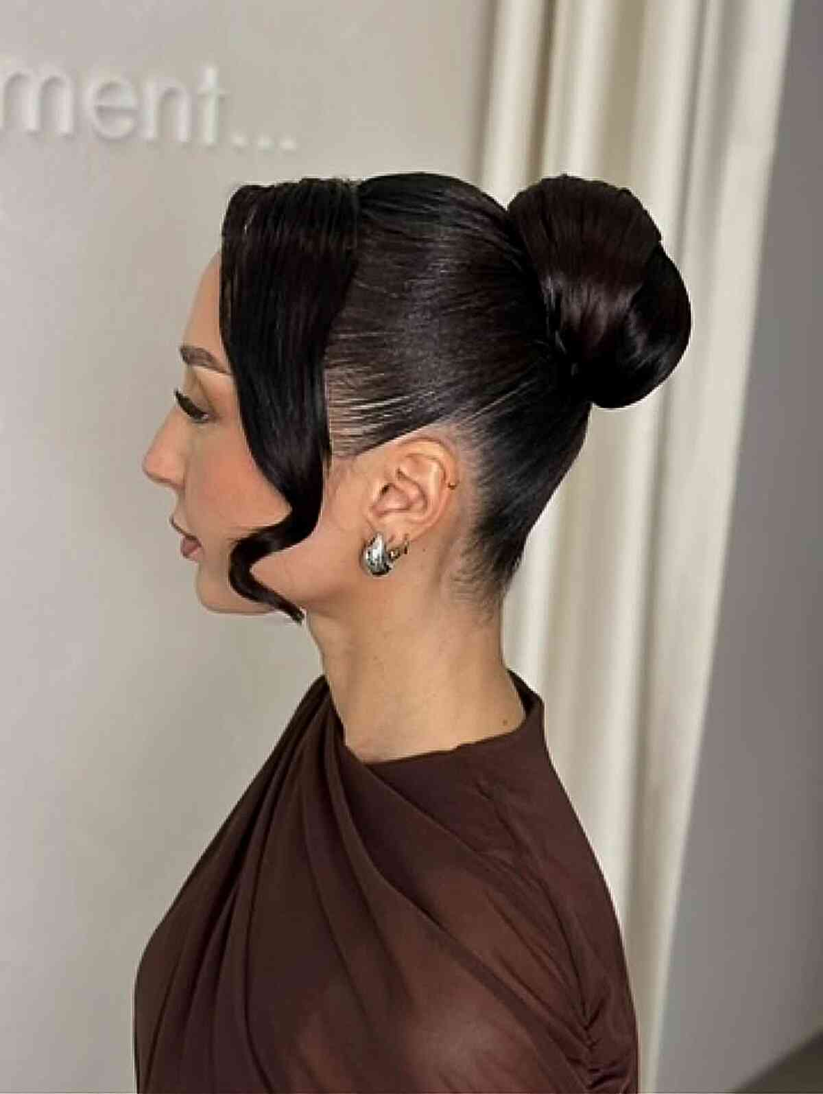 Sleek High Bun with Face-Framing Waves