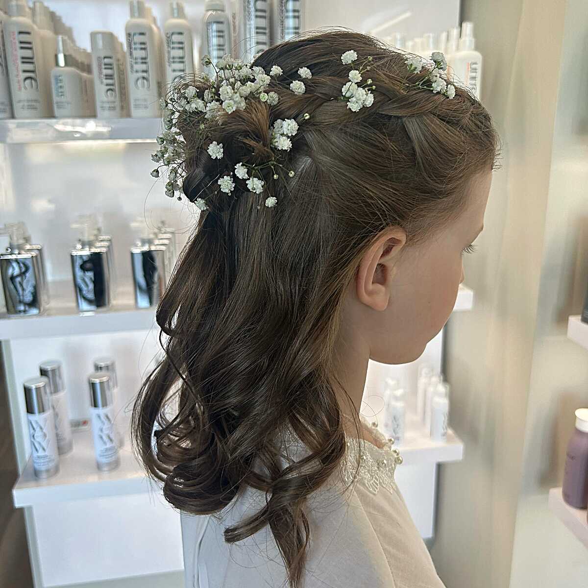 Half-up braid with fresh baby's breath and soft curls