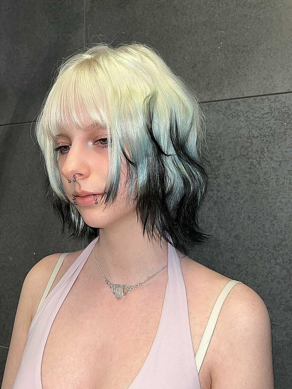 Wavy bob with platinum blonde top and black underneath