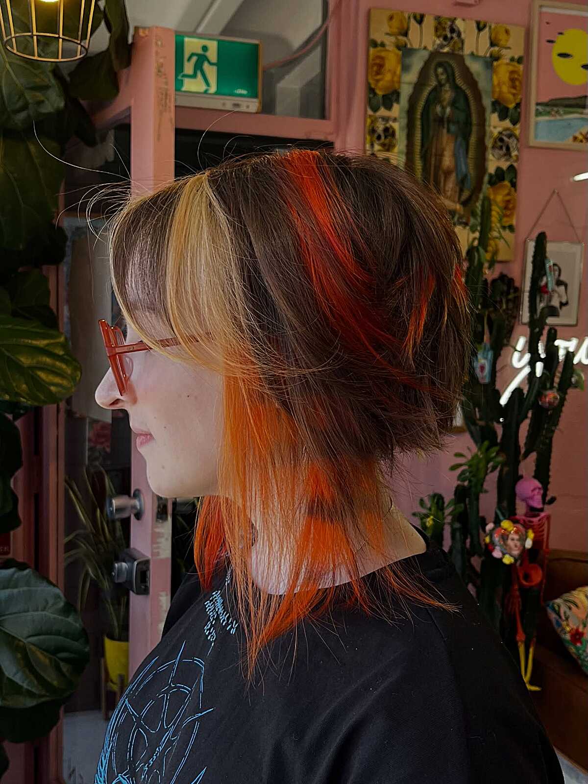 Layered shag with blonde bangs and bright orange pieces