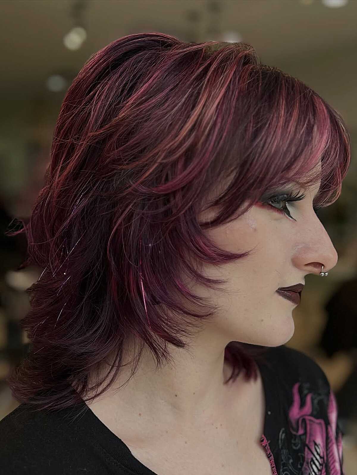 Feathered layers in deep burgundy with pink highlights