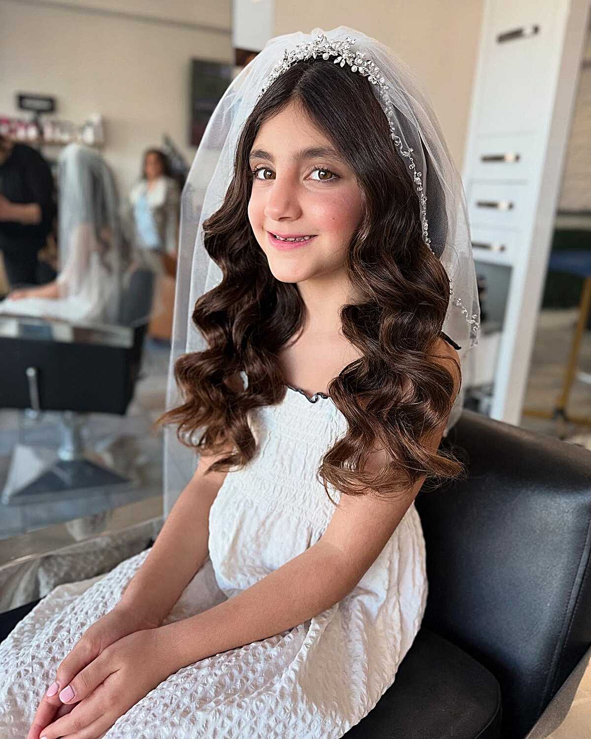 Long cascading curls with crystal tiara and sheer veil