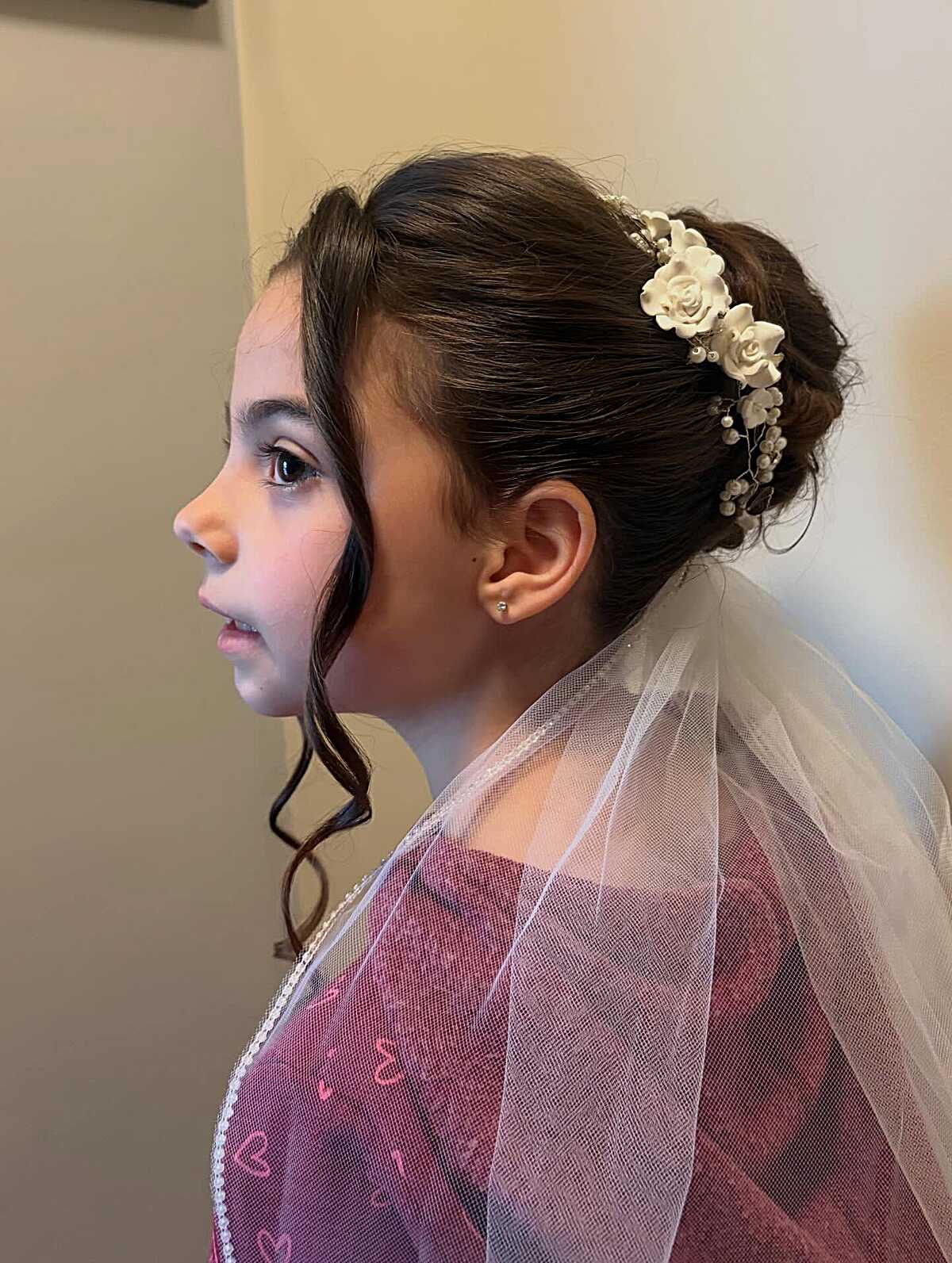 Classic low bun with porcelain rose headband and white veil