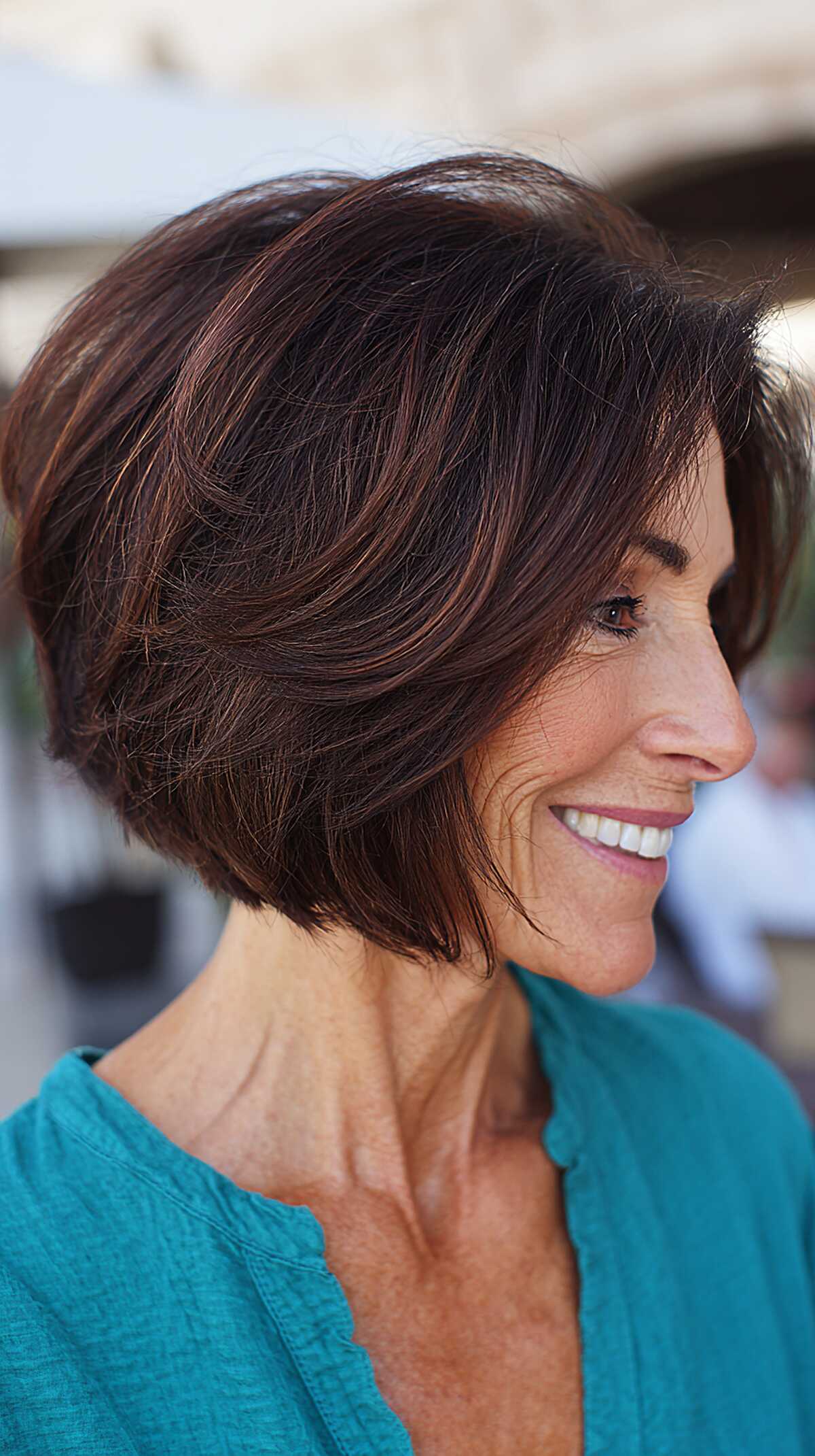 Dark chocolate layered angled bob with reddish tones
