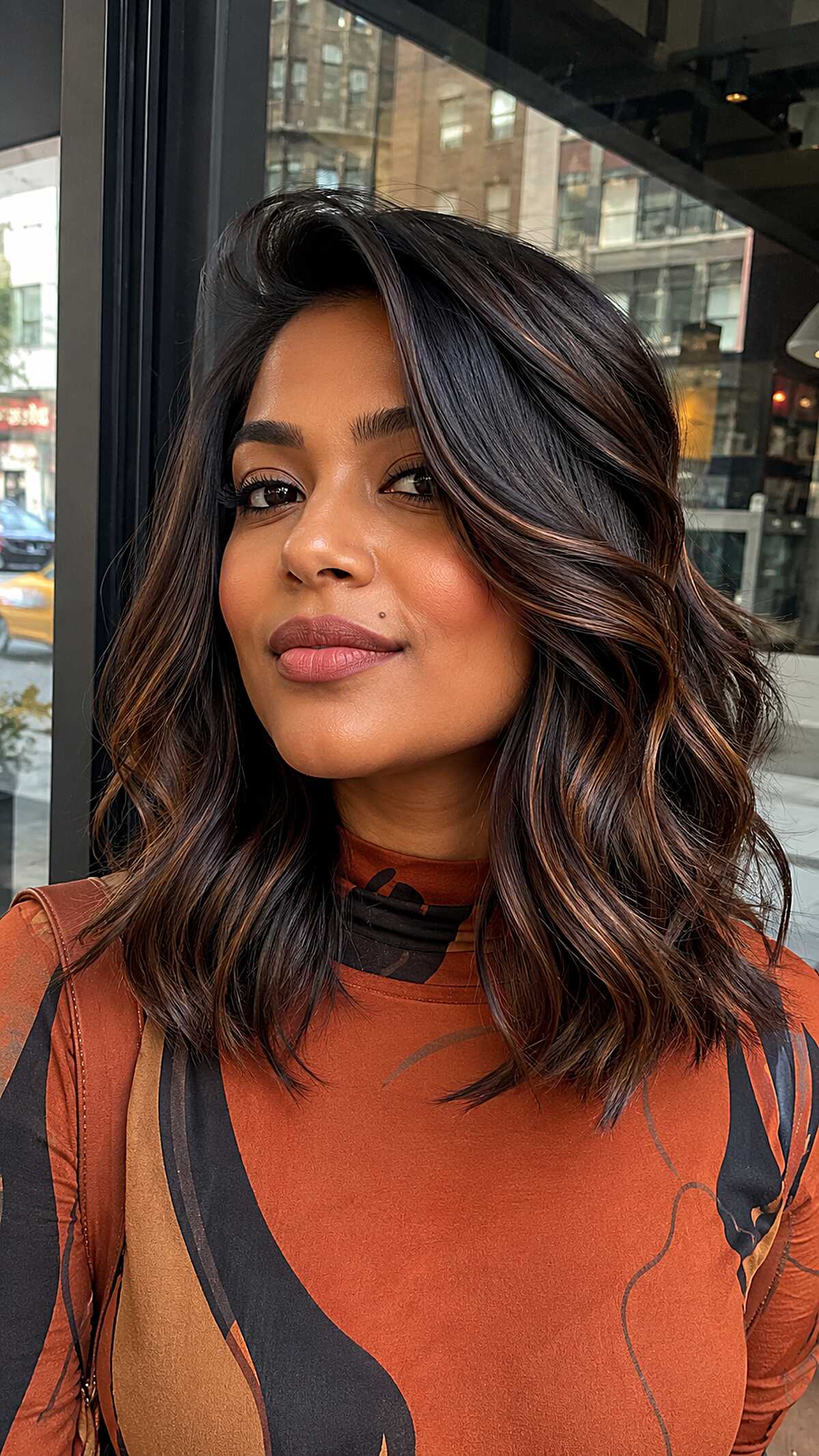 Shoulder-length dark espresso waves with copper highlights