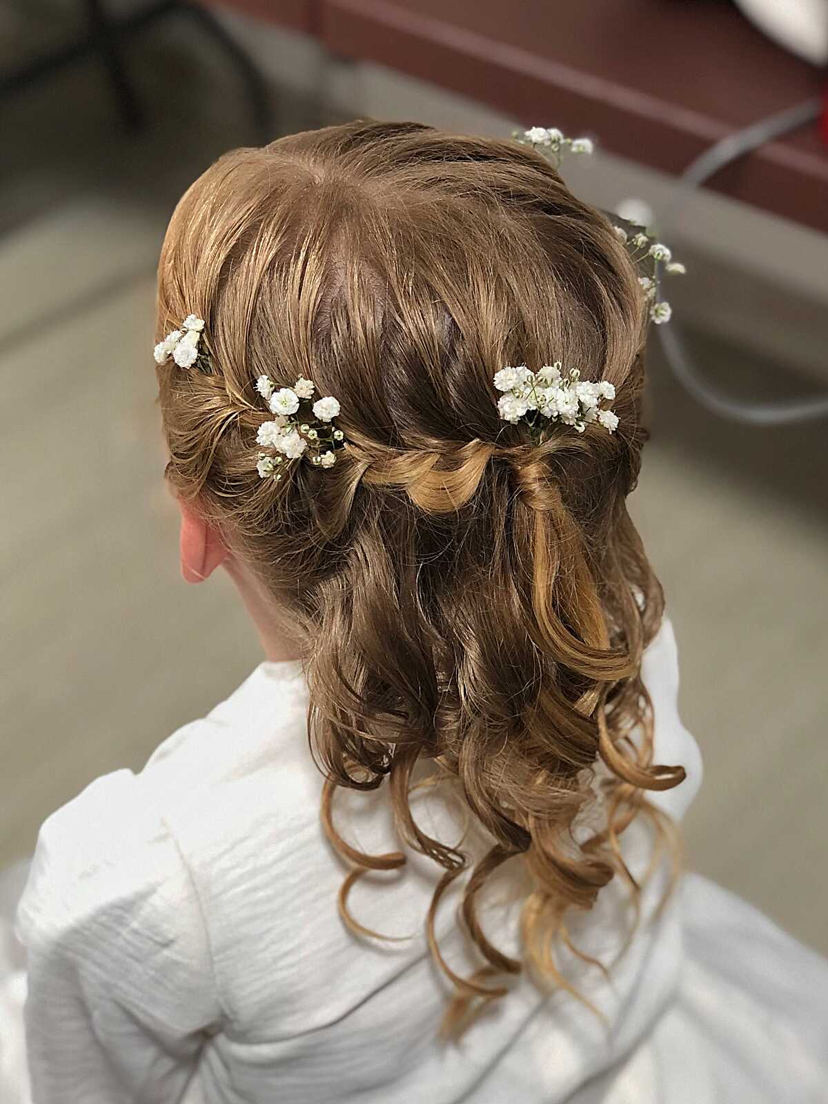 Twisted half-up style with baby's breath and soft curls
