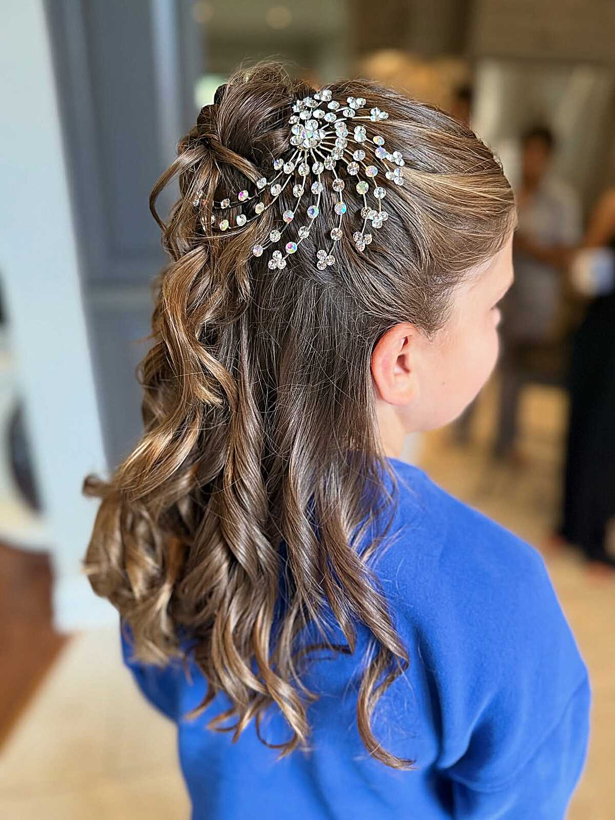 Half-up curled style with crystal starburst hair comb