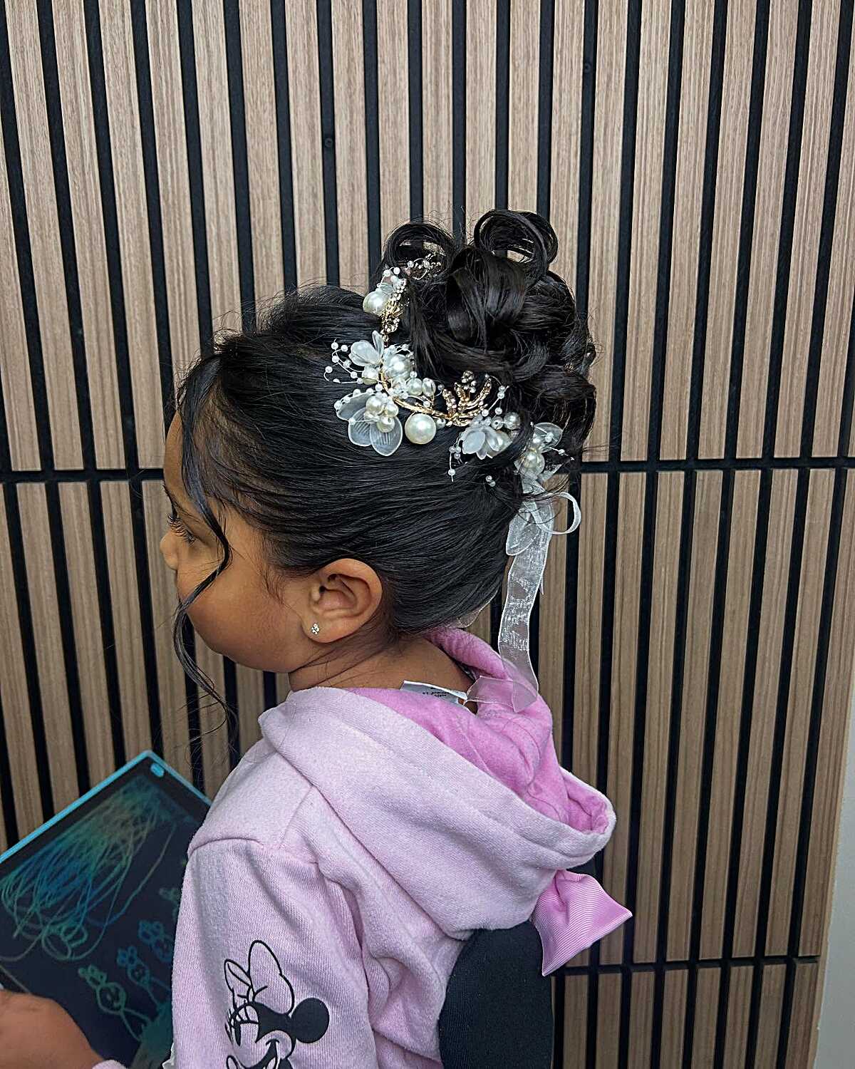 Little girl's curled updo with pearl and crystal headpiece