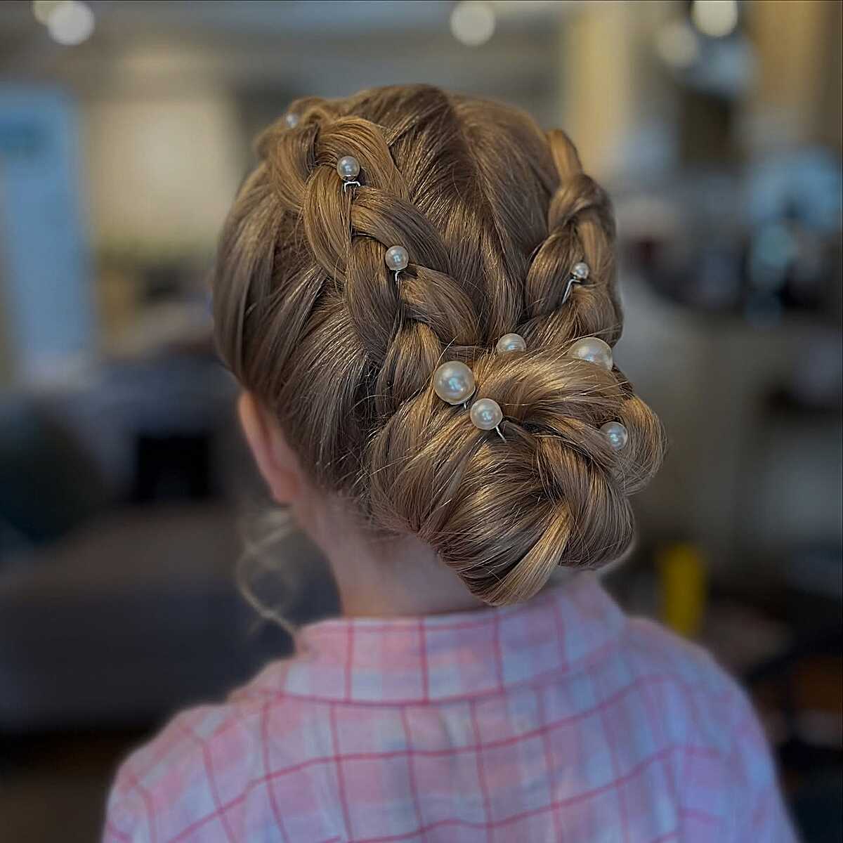 French braid updo with pearl pins into twisted low bun