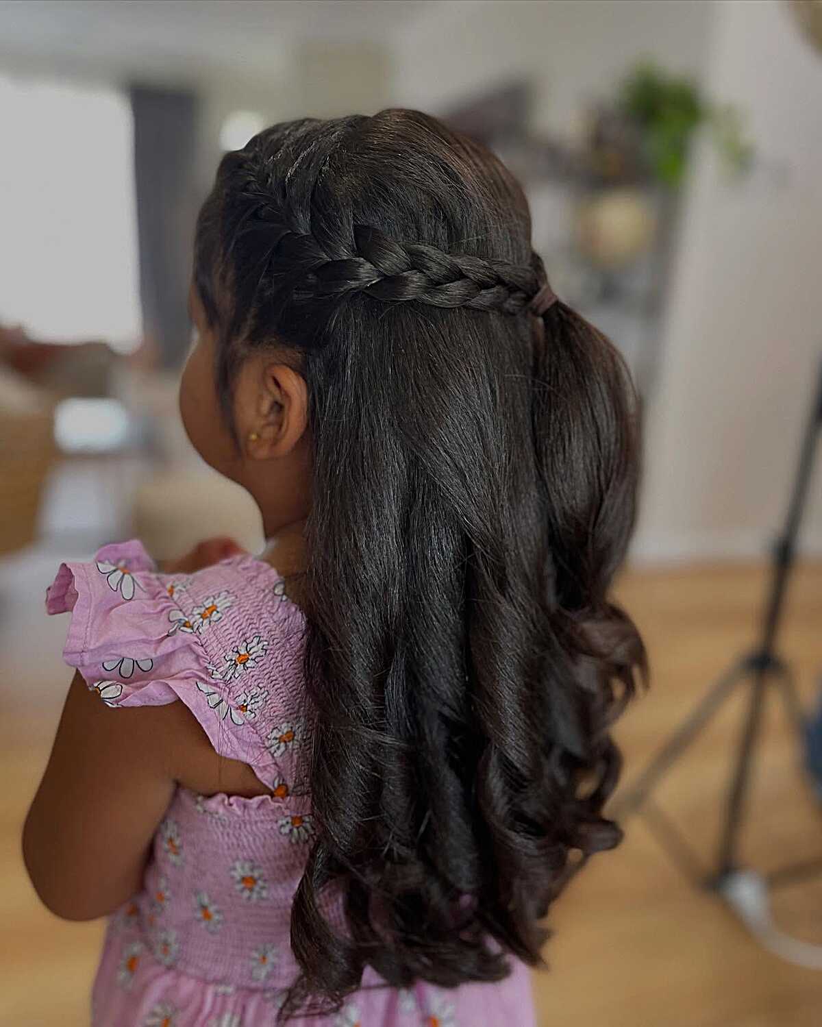 Half-down style with thick braid crown and long curls