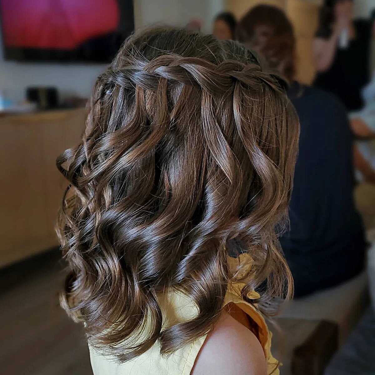 Waterfall braid with bouncy barrel curls on short hair