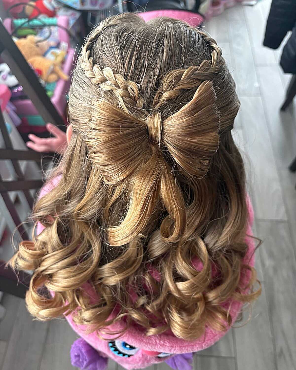 Hair bow made from hair with French braids and curled ends
