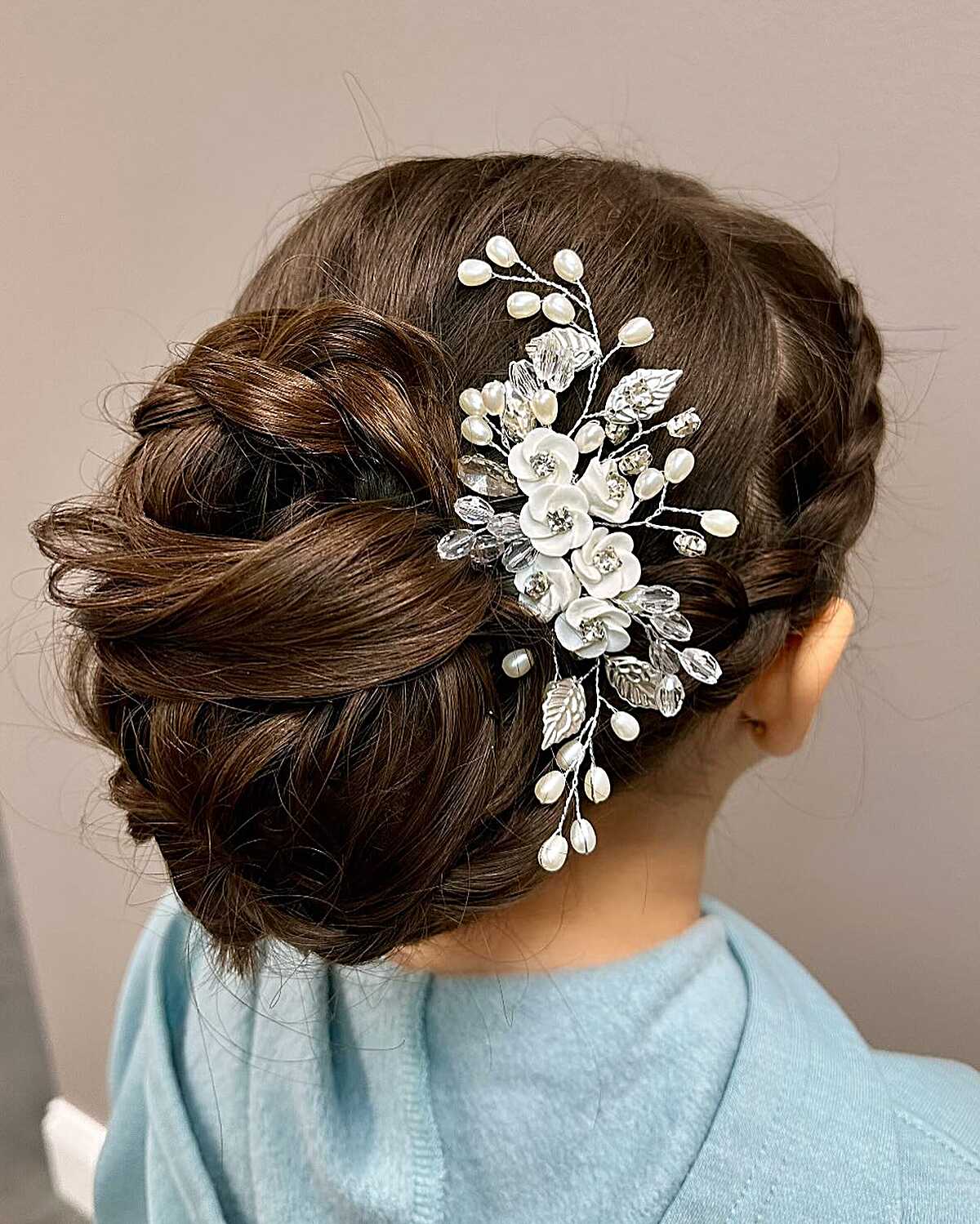 Low twisted bun with large pearl and crystal floral hair comb