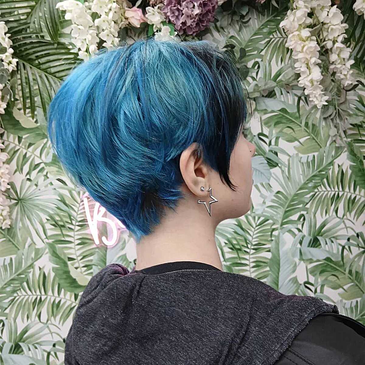Teal blue pixie cut tapered at the nape