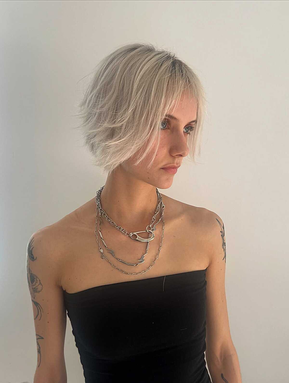Razored platinum bob with dark grown-out roots