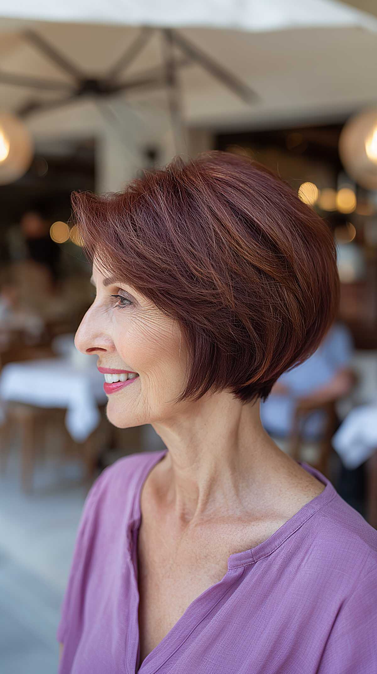 Plum-toned sleek angled bob with side-swept bangs