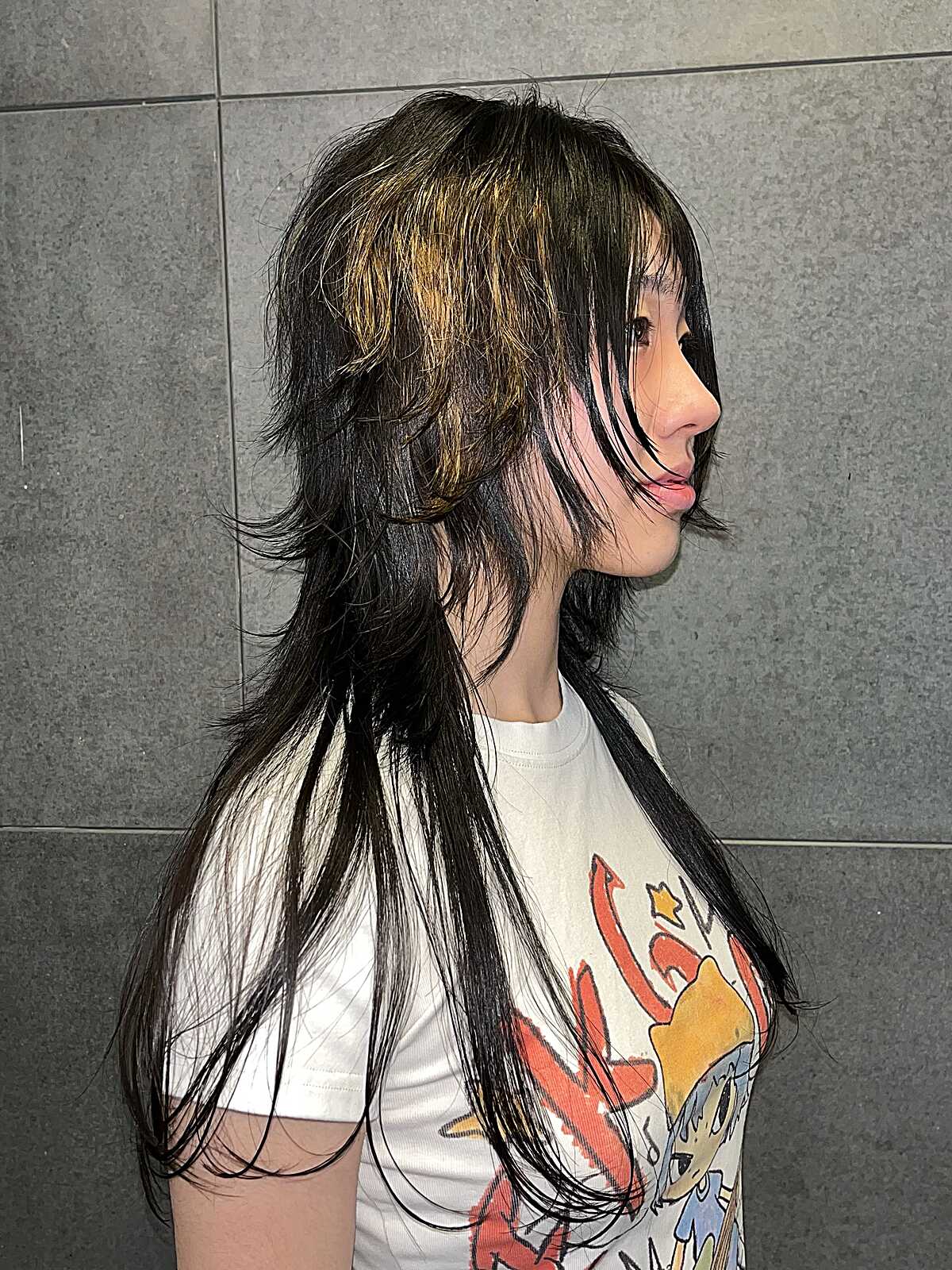 Long black wolf cut with golden face-framing highlights