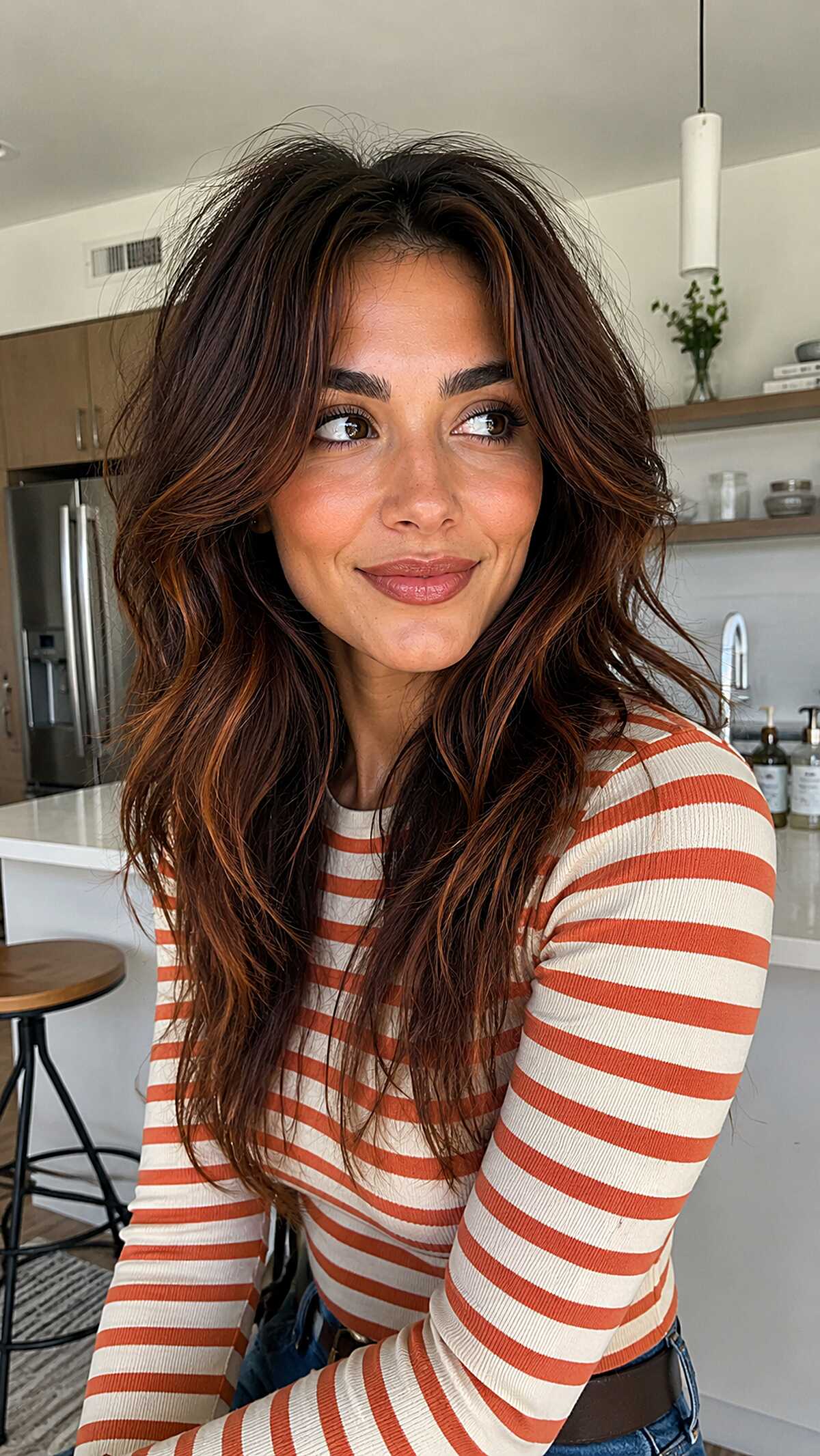Long wavy auburn hair with warm cinnamon highlights