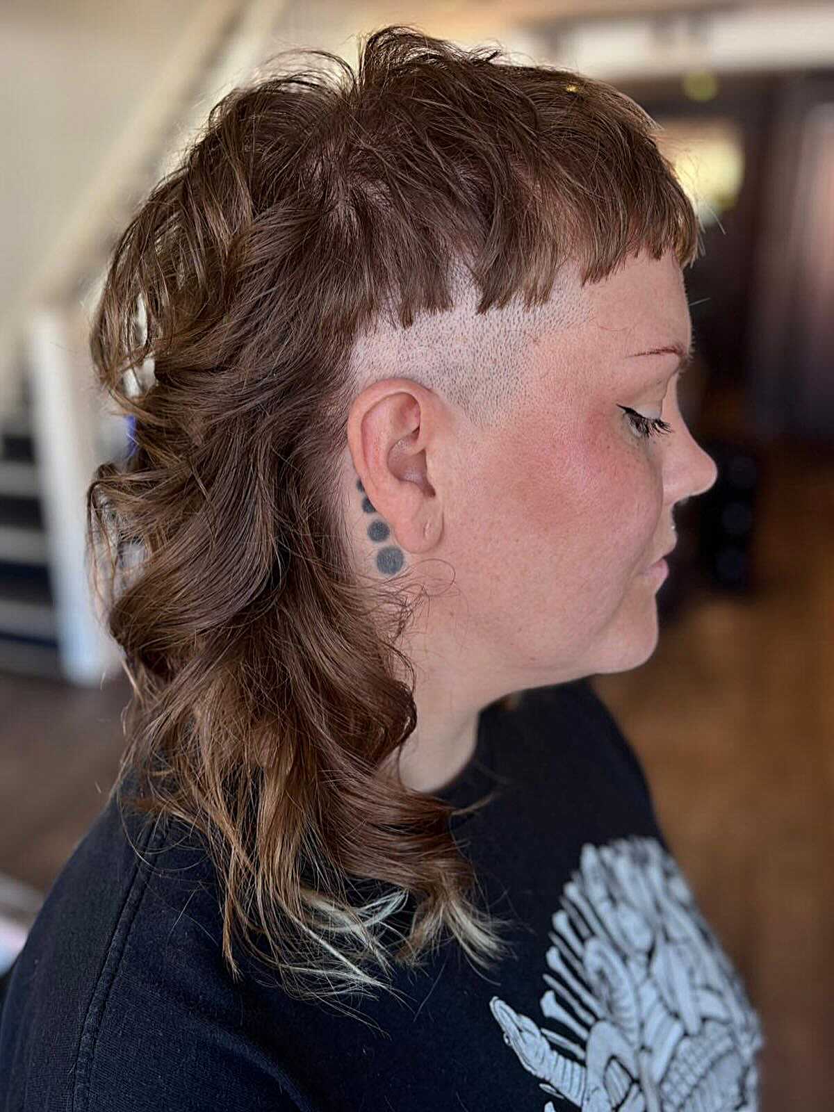 Wavy brown mullet with shaved sides and long back