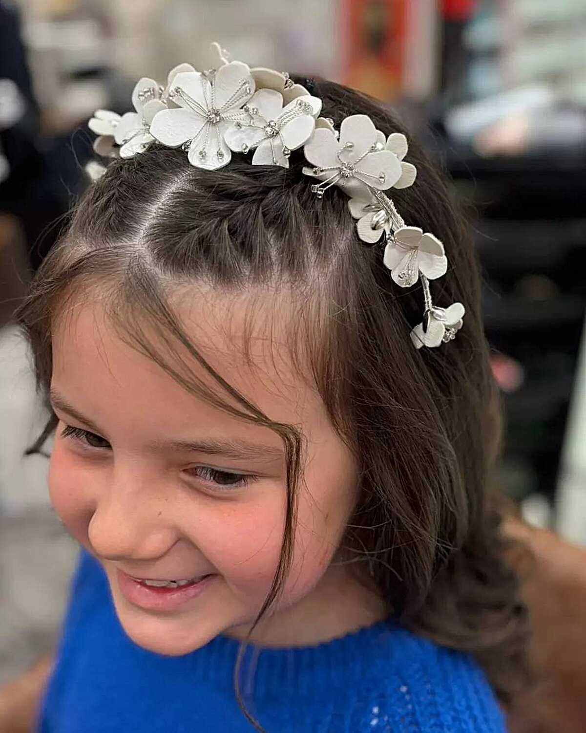 Short bob with large white floral headband for Communion