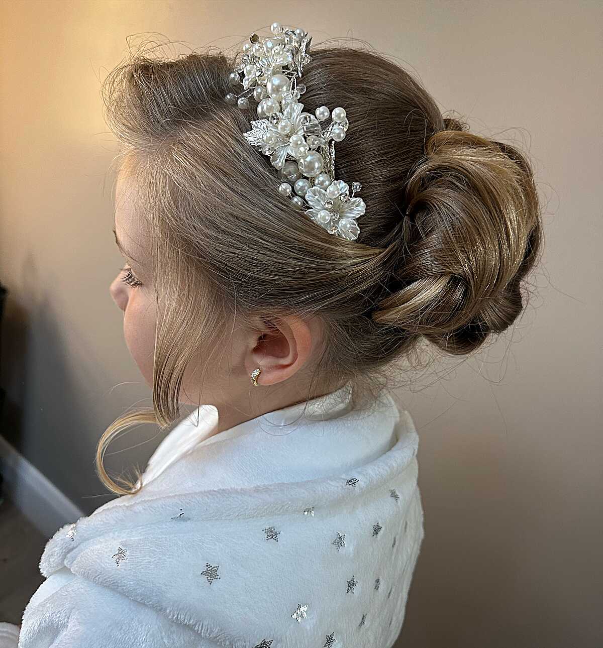 Soft rolled updo with pearl and leaf comb on blonde hair