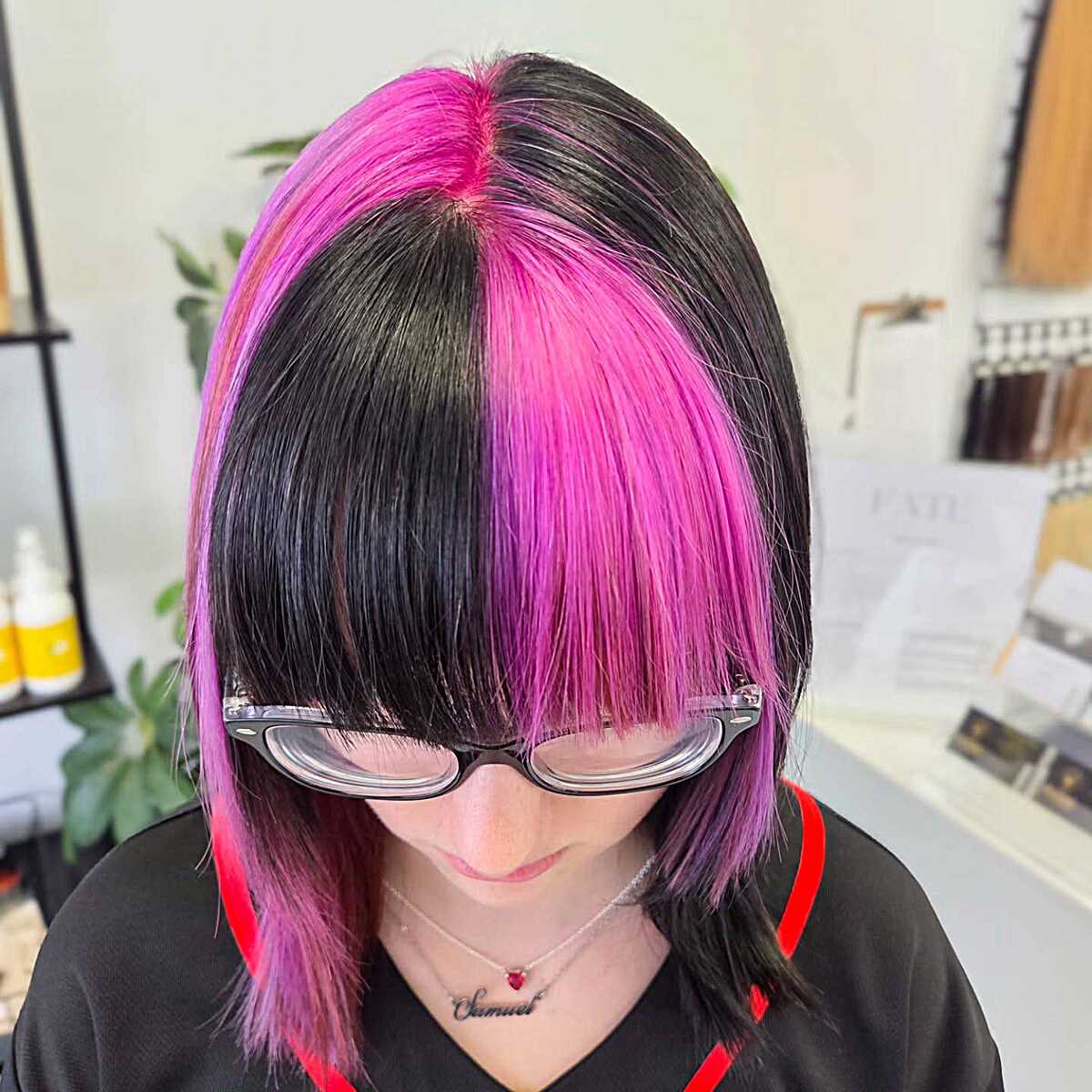 Half pink half black bob with blunt bangs and glasses