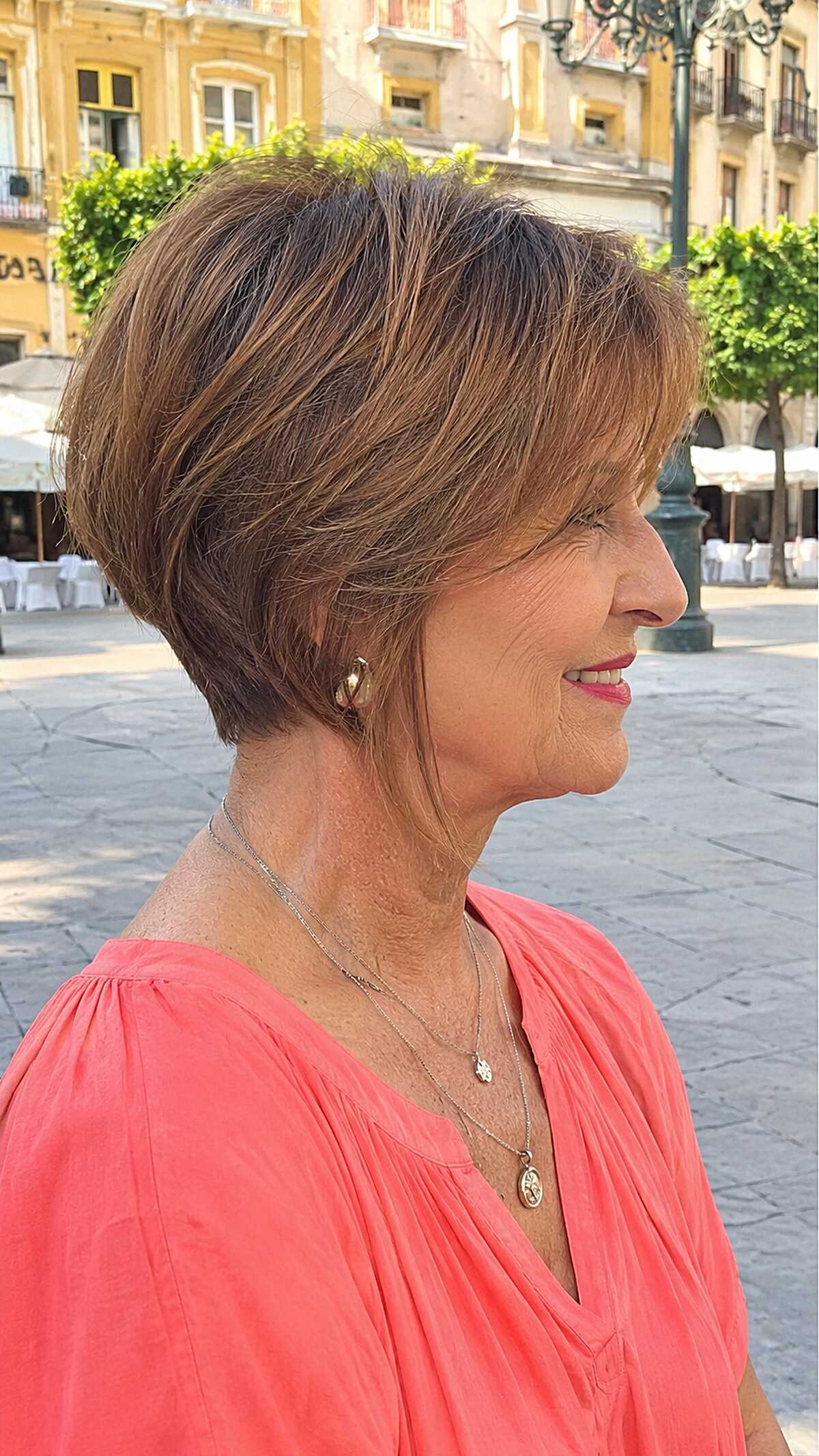 Tapered brunette bob with golden highlights outdoors