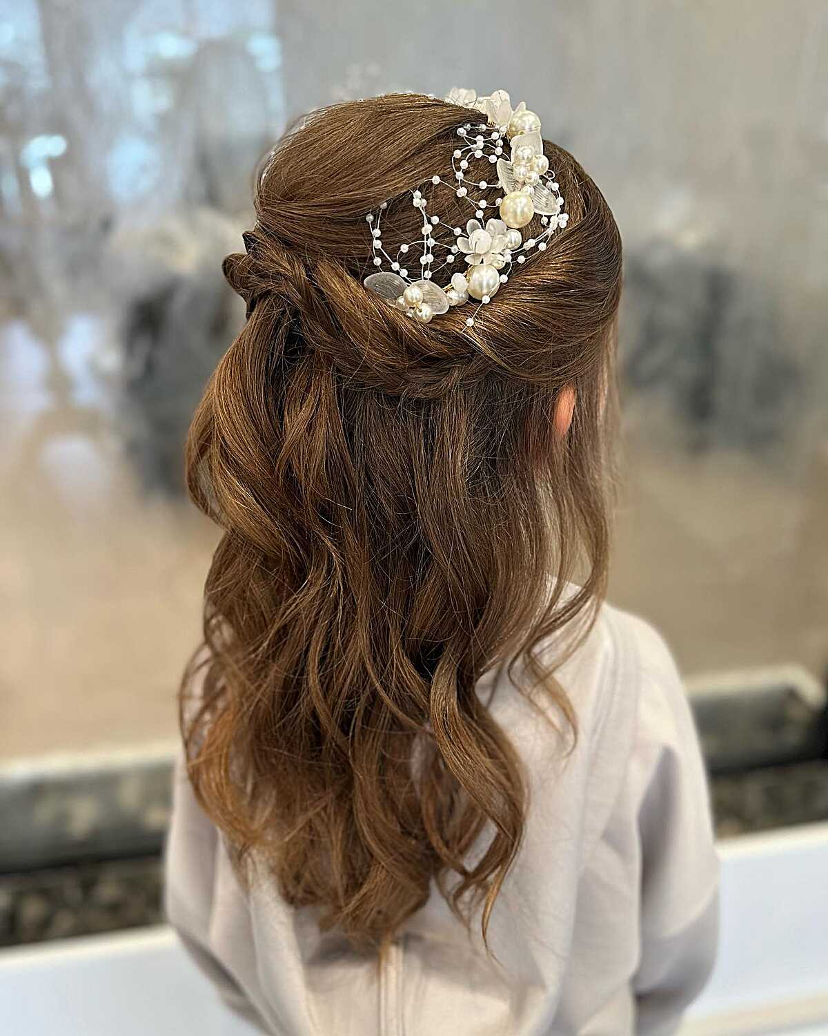 Twisted half-up with pearl spray comb and loose waves