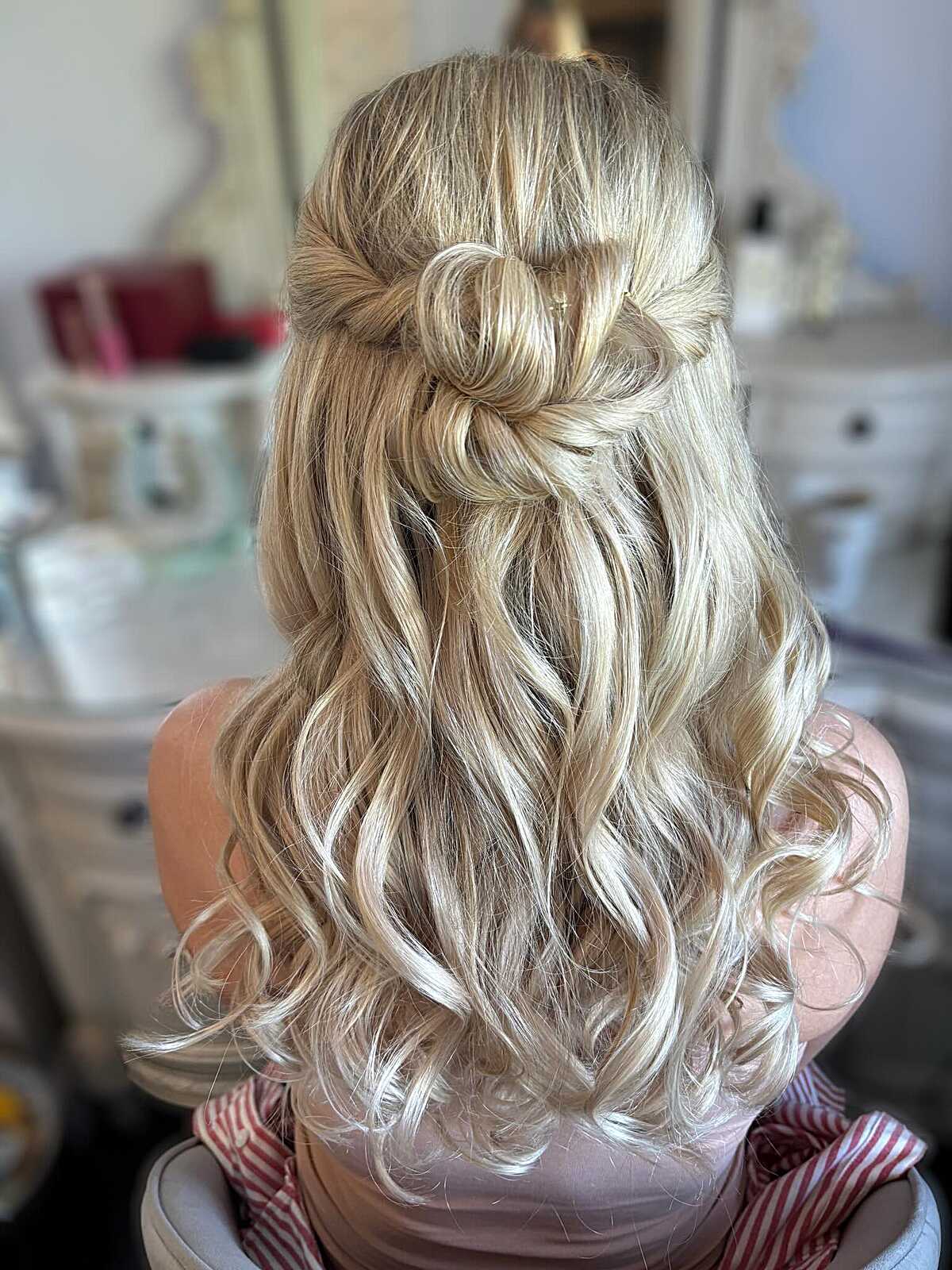 Blonde half up with rosette twist and soft curls