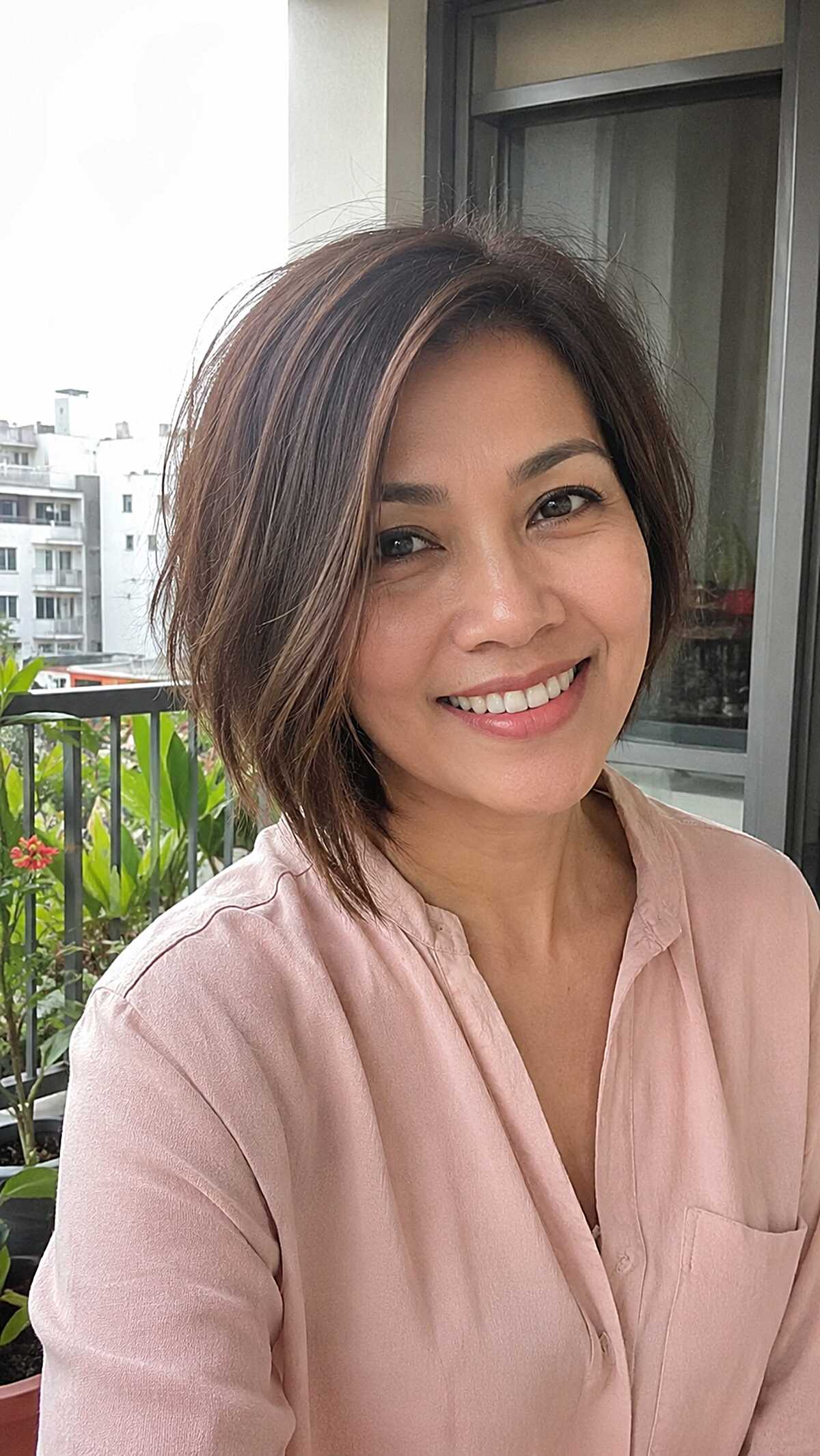Brunette asymmetrical bob with sun-kissed highlights