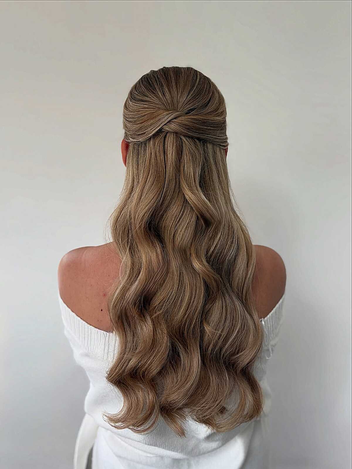 Light brunette half up knot with smooth satin waves