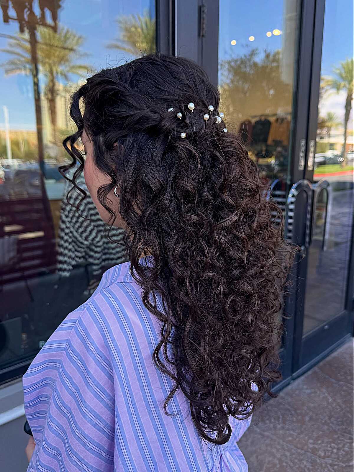 Natural curly half up with pearl pin accents