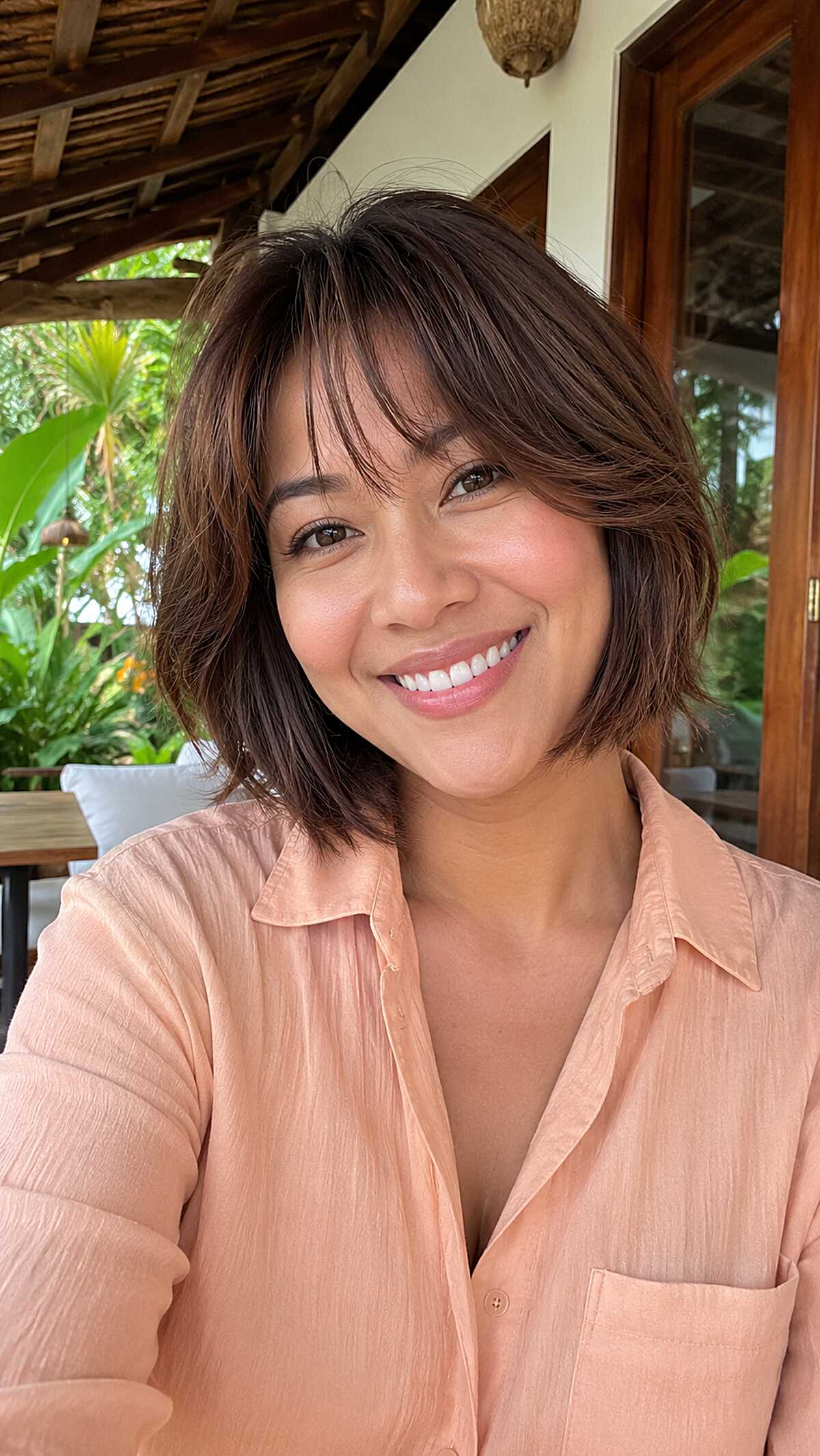 Dark brown textured choppy bob with wispy bangs