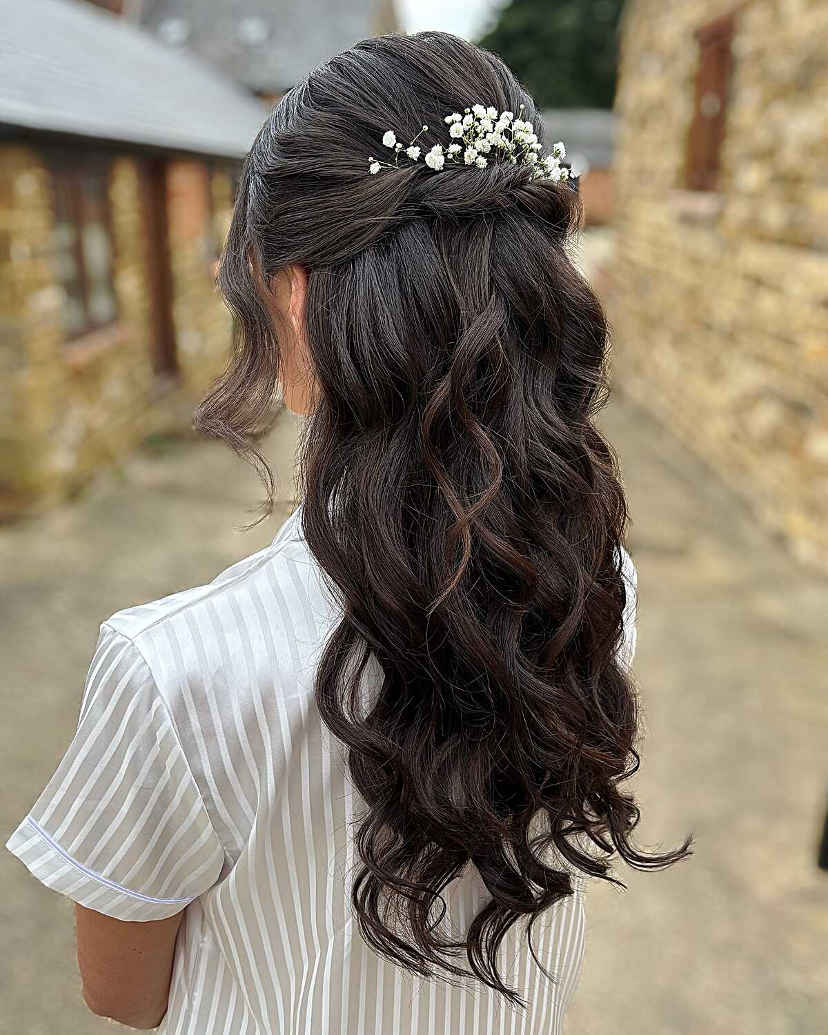 Dark brunette half up with baby's breath flowers