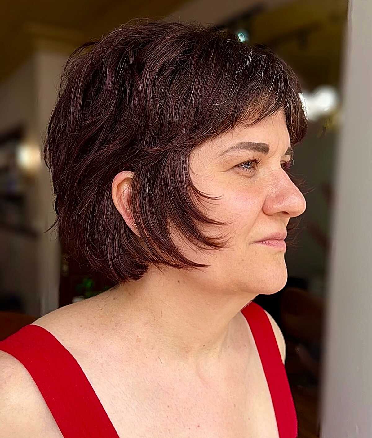 Deep plum shaggy bixie with wispy bangs and texture