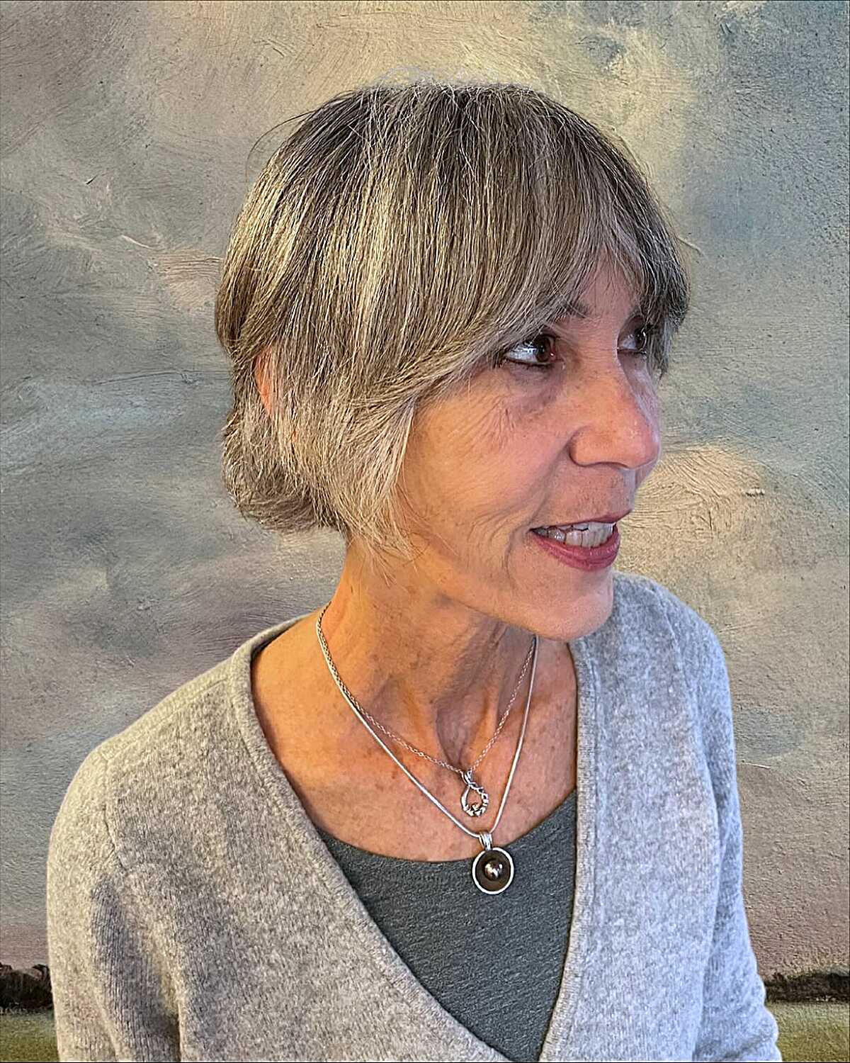 Feathered side-swept bixie on fine gray and blonde hair