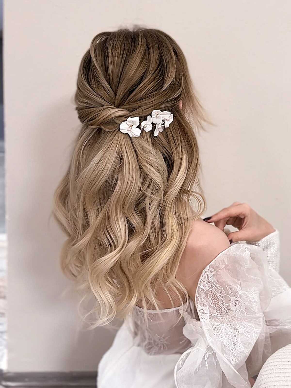 Bridal half up with white floral pins and waves