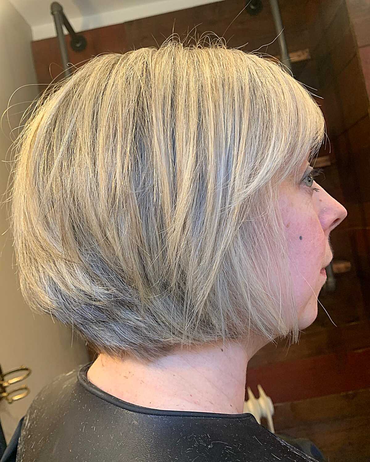 Full blonde bixie bob with heavy bangs and stacked back