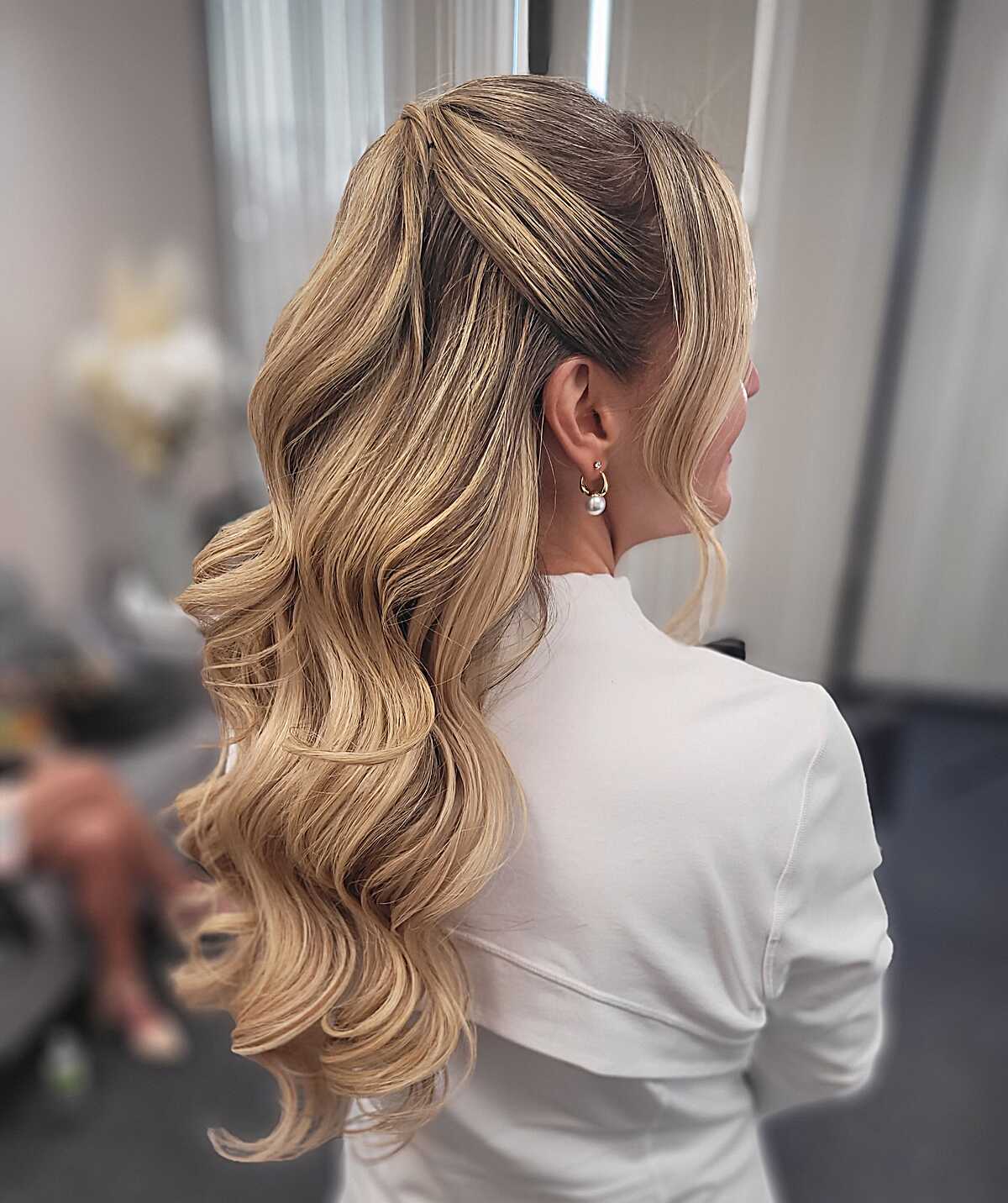 Glamorous blonde half up with voluminous waves