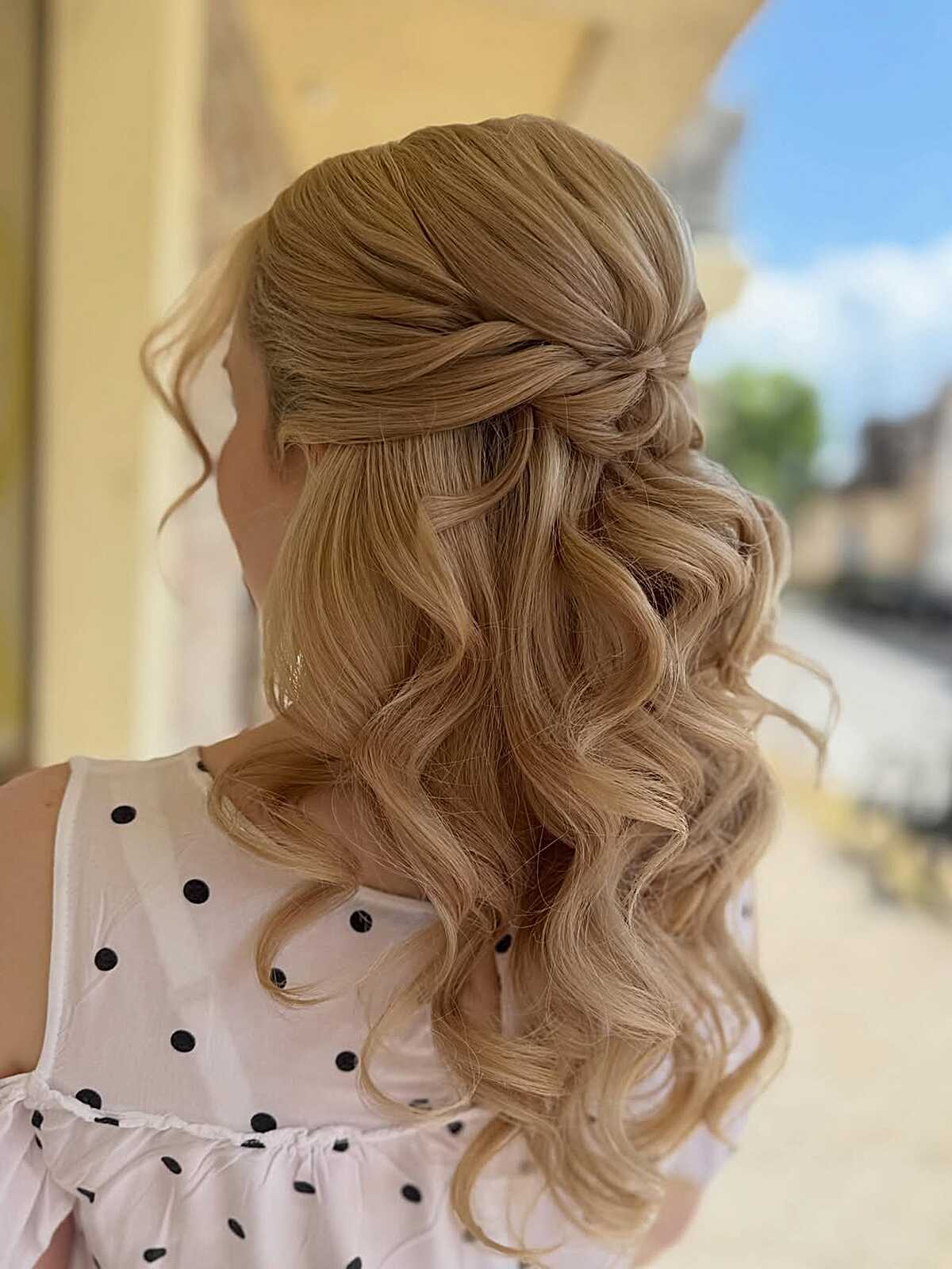 Golden blonde half up twist with bouncy curls