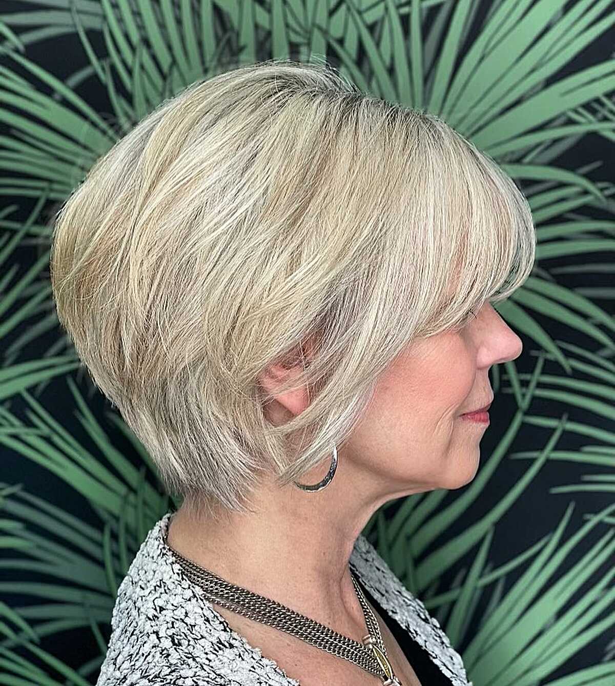 Layered blonde bixie bob with side-swept bangs and volume