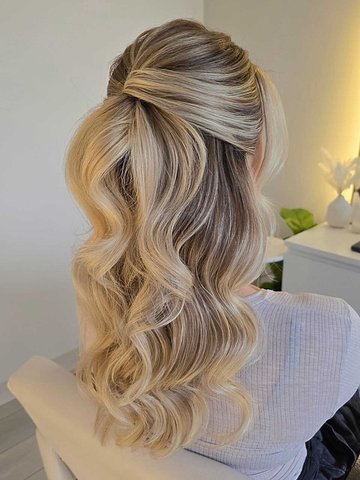 Blonde half up with volume and soft body waves