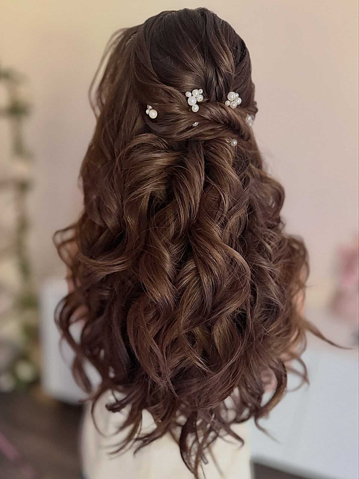 Brunette half up with pearl pins and cascading curls