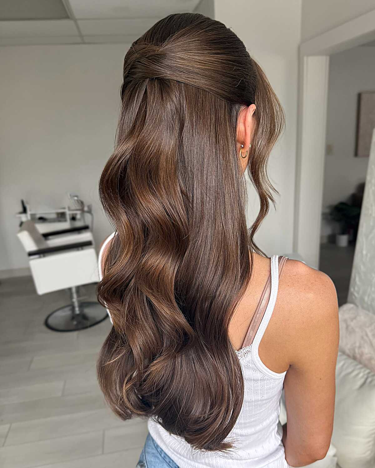 Sleek dark brown half up with polished waves