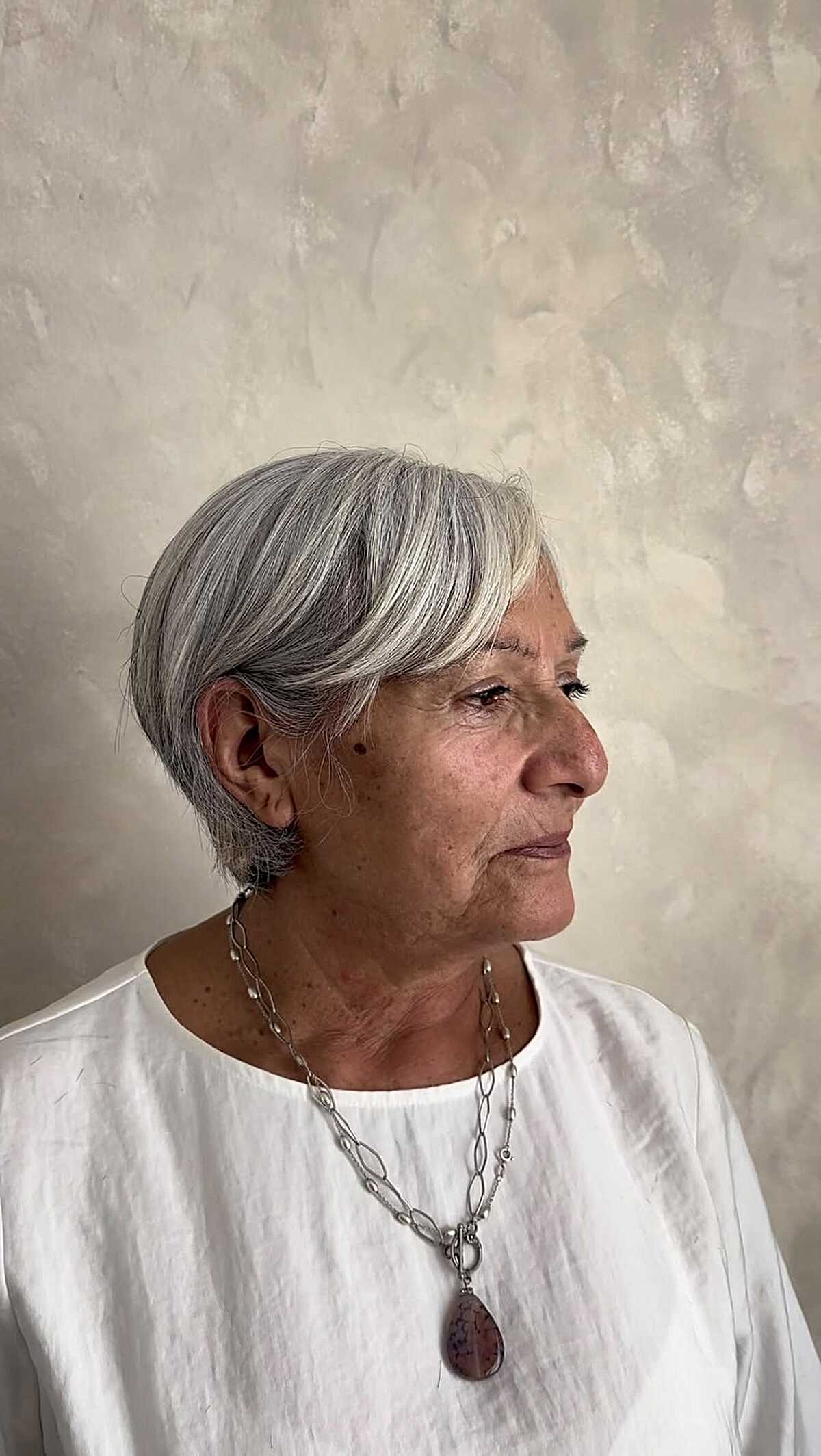 Silver side-parted bixie with tucked sides and soft layers